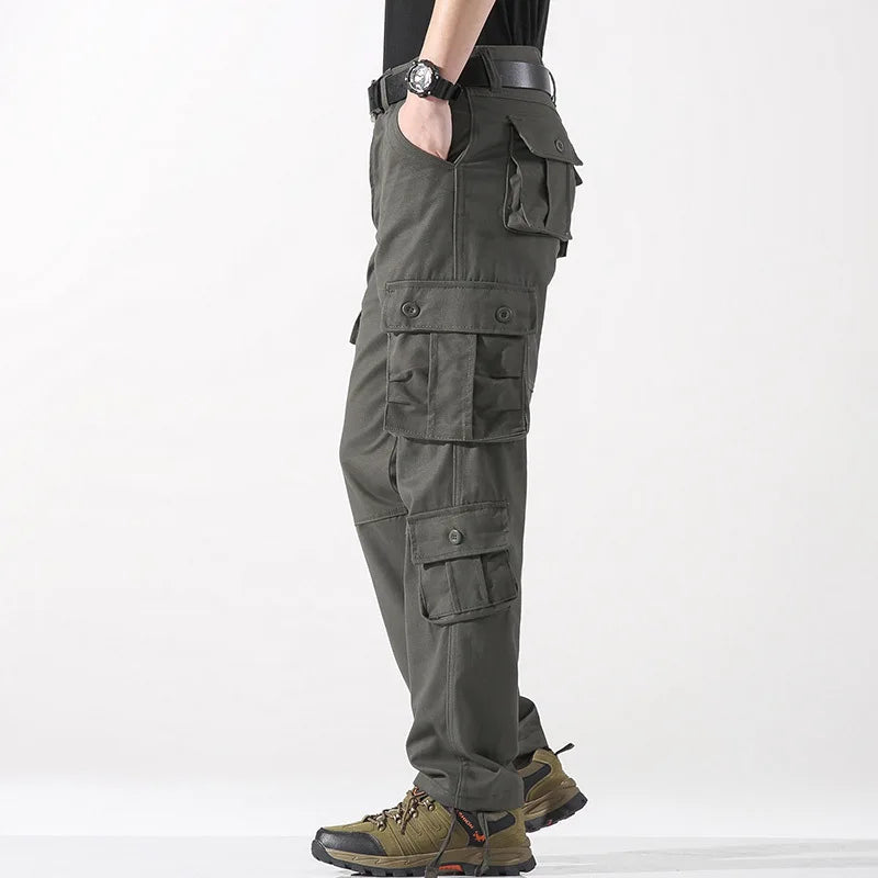 Person wearing green cargo pants on a white background