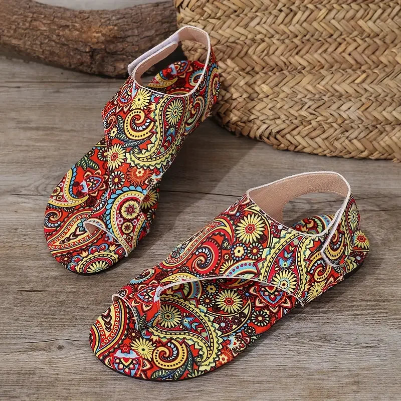 Colorful patterned shoes on a wooden surface with a woven mat in the background