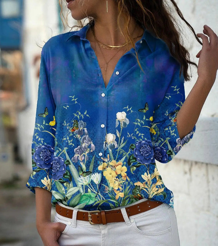 Woman wearing a blue floral shirt with a blurred background