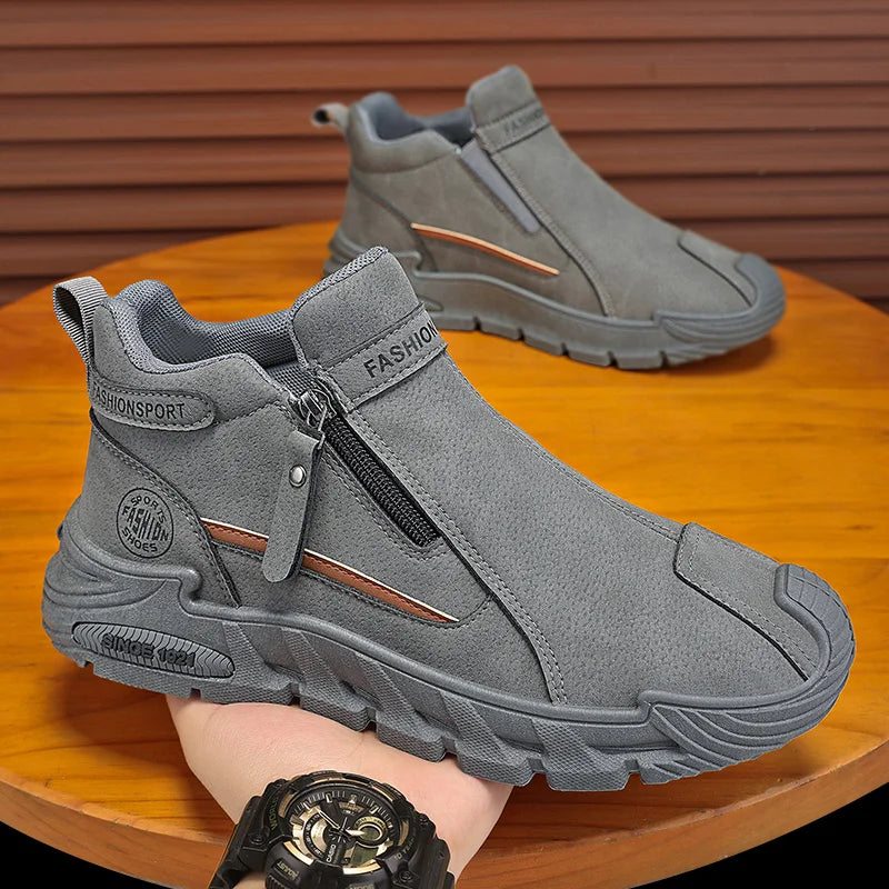 Gray ankle boots with a zipper on a wooden surface