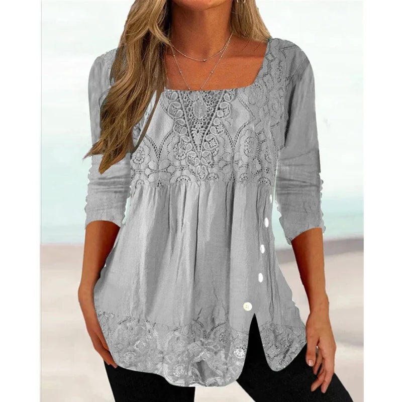 Woman wearing a gray lace blouse with a blurred background