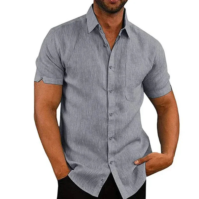 Man wearing a gray short-sleeve button-up shirt on a white background