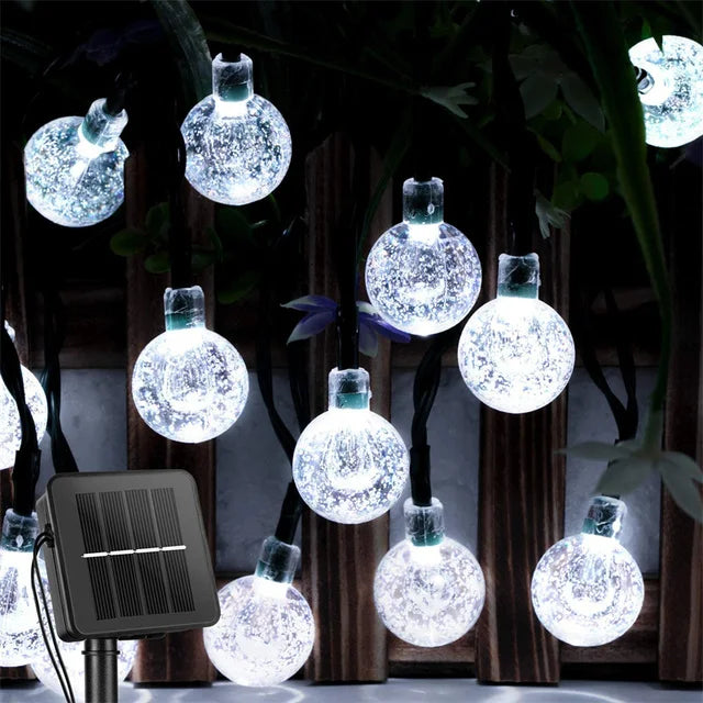 Solar-powered crystal globe LED string lights for outdoor décor. white
