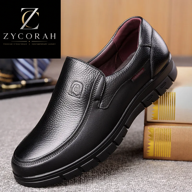 A black pebbled leather slip-on loafer with a thick black lug sole, shown in a styled setting with a ZYCORAH brand overlay in the top-left corner.