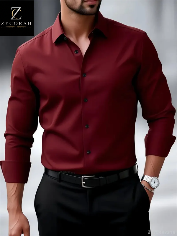 A man wearing a long-sleeve button-down dress shirt in deep burgundy, paired with black trousers and a black belt. The ZYCORAH logo is visible in the top-left corner.