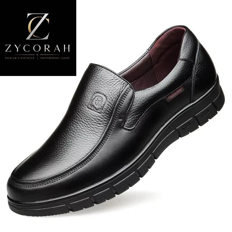 A black pebbled leather slip-on loafer for men, featuring a thick black lug sole and a small embossed logo on the side, shown on a white background with a ZYCORAH brand logo in the top-left corner.