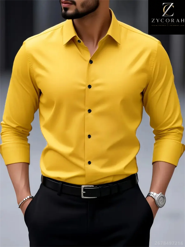 A man wearing a bright yellow long-sleeve button-down dress shirt tucked into black trousers with a black belt. The photo is cropped from the lower face to the hips, with the brand logo 'ZYCORAH' visible in the top right corner.