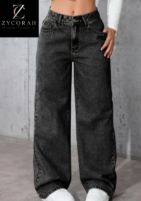 A person wearing dark gray wide-leg denim jeans with a faded wash, paired with a white long-sleeve top and white sneakers. The image has a black brand overlay in the top-left corner reading 'ZYCORALI'.