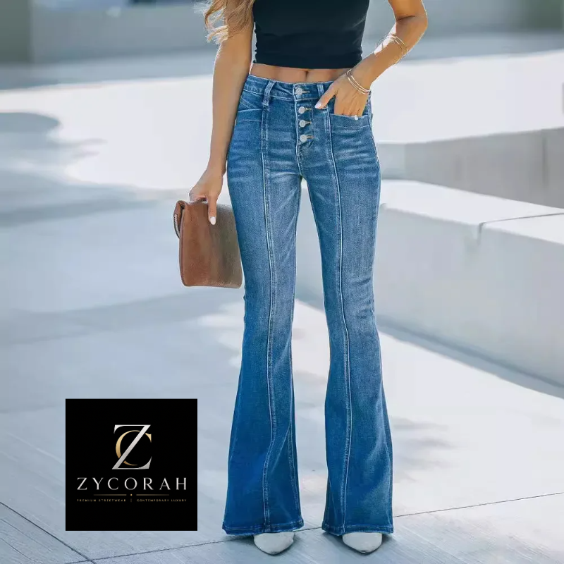 A model wearing high-waisted, button-front flare jeans in medium blue denim, paired with a black crop top and white sneakers, holding a brown clutch bag. A black square logo for 'Zycorah' is visible in the bottom-left corner.