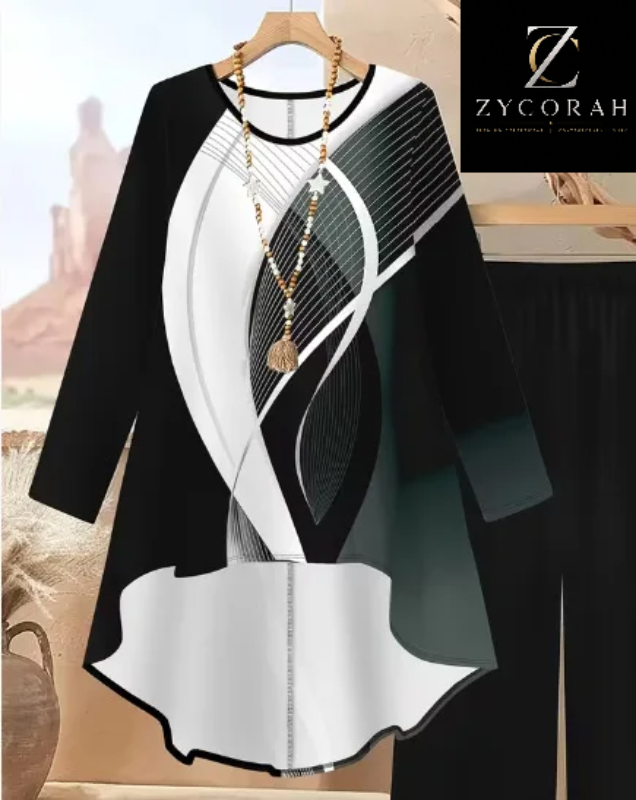 A long-sleeve tunic dress with a modern abstract print in black, white, and gray, hanging on a wooden hanger with a gold necklace. The brand logo 'Z YCORAH' is visible in the top right corner.