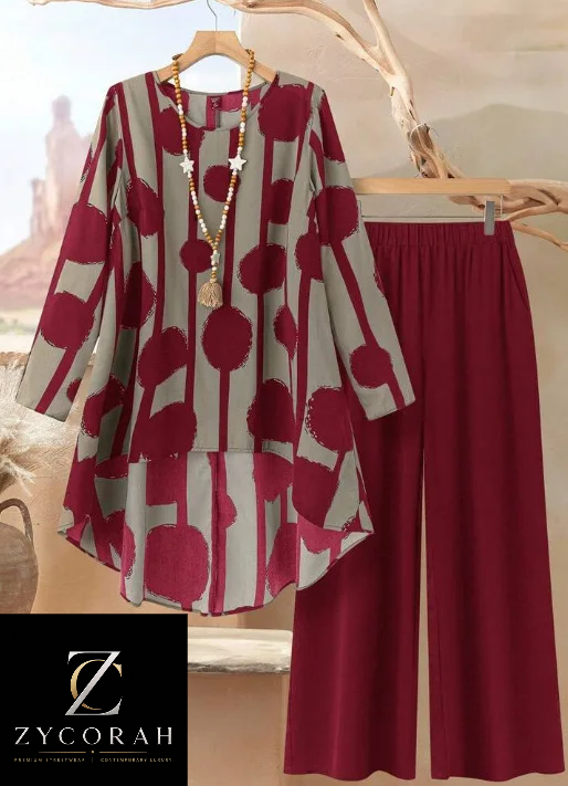 A women's two-piece outfit set featuring a long-sleeve tunic top with a red and beige abstract pattern and matching red wide-leg pants, displayed on wooden hangers against a neutral background with a Zycorah brand logo overlay.